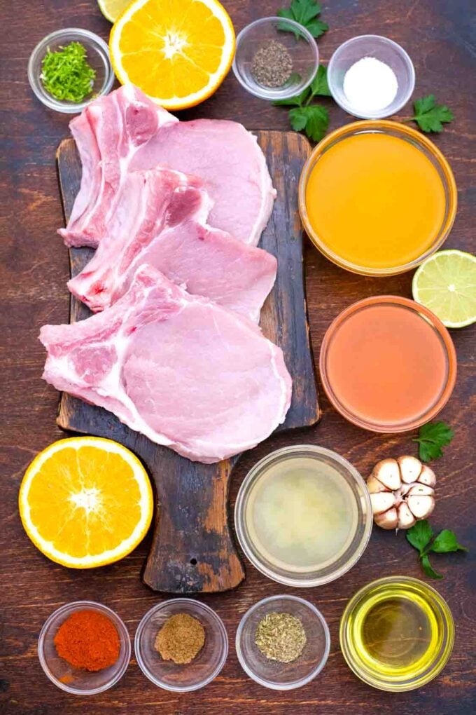 overhead shot of bone in pork chops orange juice lime juice and spices