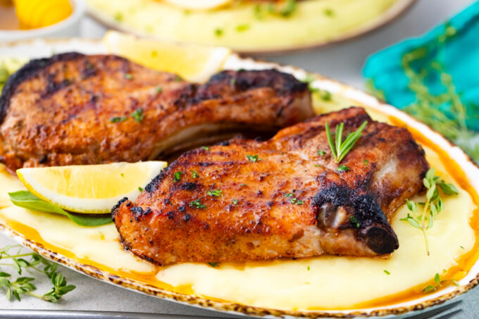Juicy grilled pork chops over mashed potatoes.