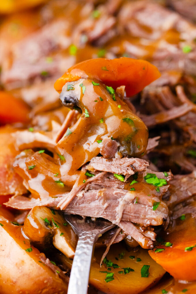 A forkful of tender, shredded Instant Pot pot roast.