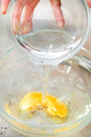 adding water to an egg in the bowl