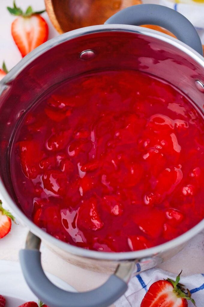 Homemade strawberry pie filling in a saucepan.