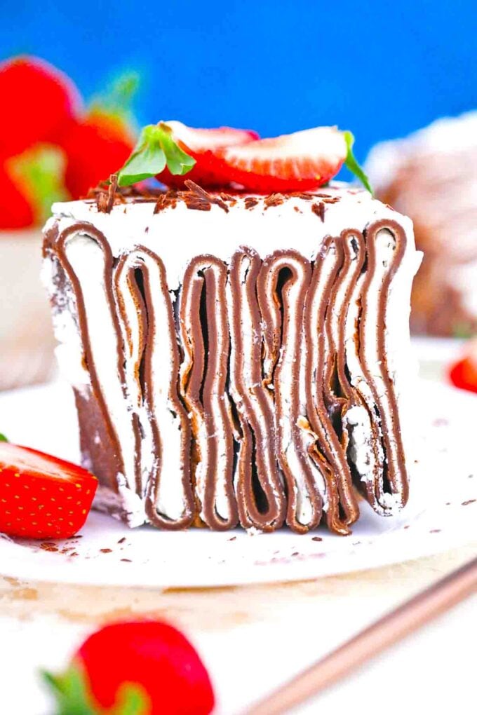 homemade chocolate crepe cake with whipped cream and strawberries