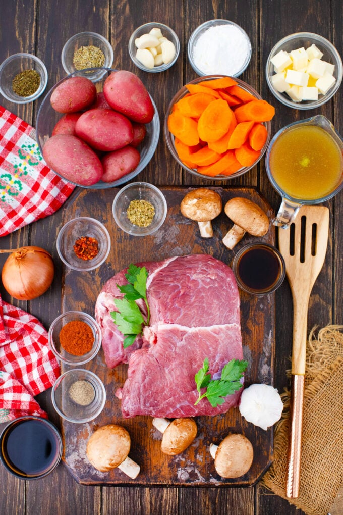 Overhead shot of instant pot pot roast ingredients in bowls on a table.