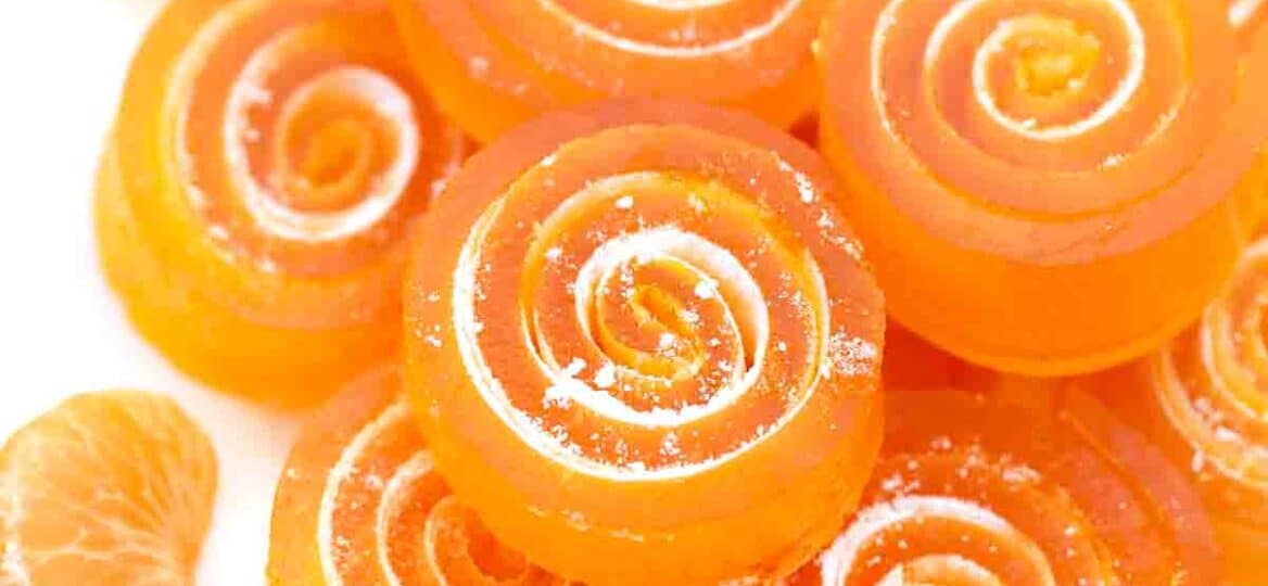 orange jelly candy stacked on a plate