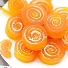 orange jelly candy stacked on a plate