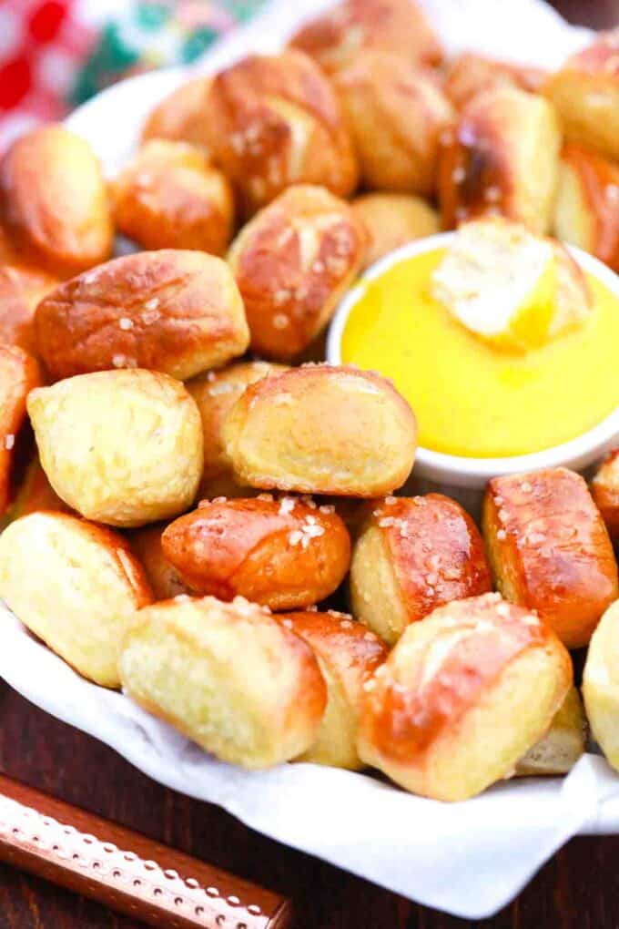 a serving plate with pretzel bites and honey mustard sauce