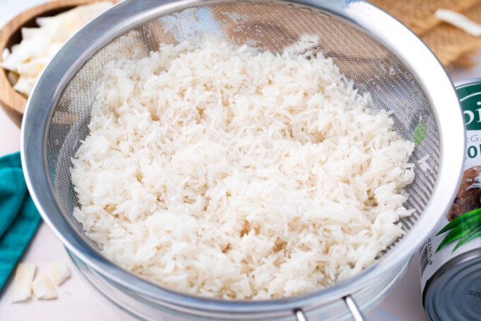 Rinsing rice in a colander.