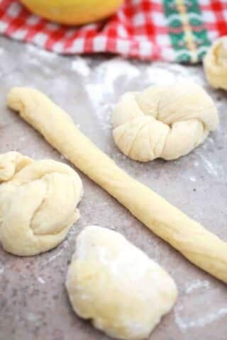 rolling dough to make sweet bread rolls