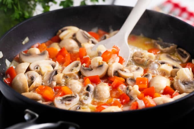 Sautéing veggies in a skillet.