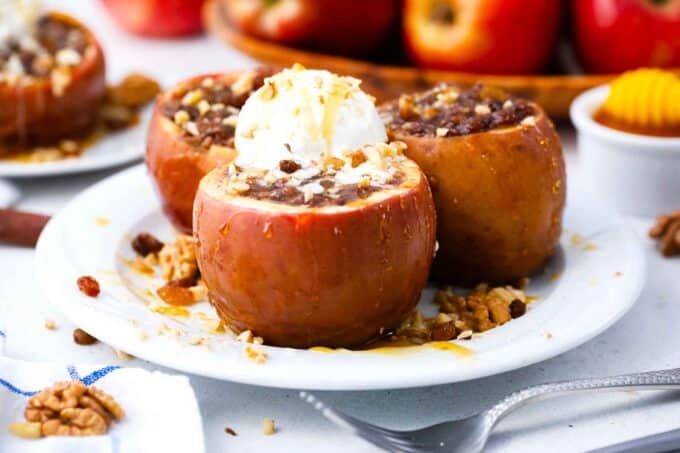 a plate of stuffed slow cooker baked apples topped with ice cream