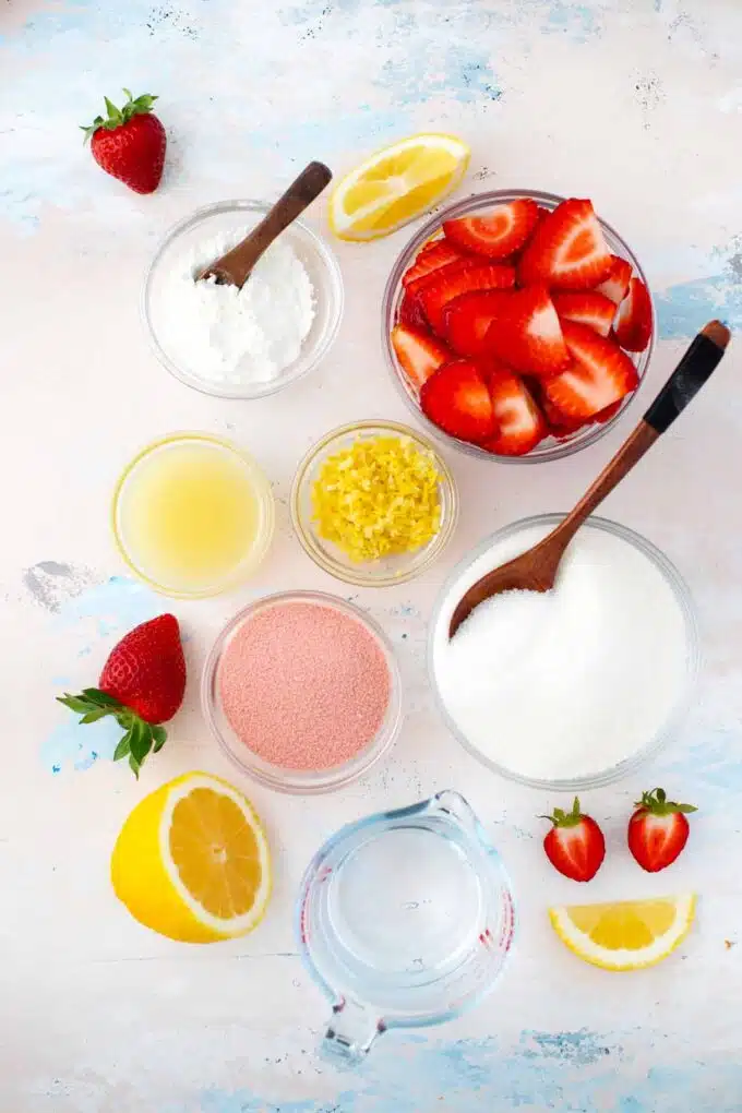 overhead shot of strawberry pie filling ingredients in bowls on a table