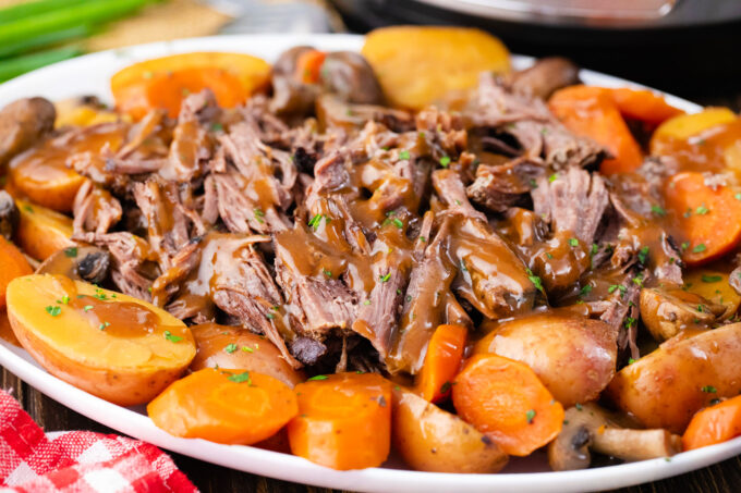 A serving plate with Instant Pot pot roast and veggies.