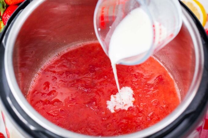 Adding cornstarch slurry to instant pot strawberry jam.