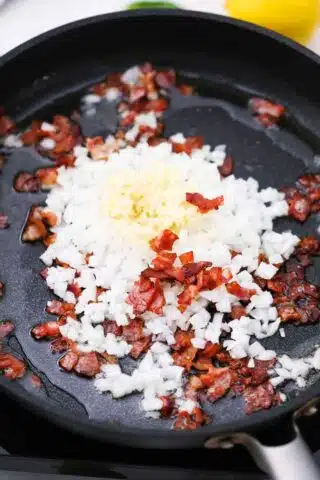 bacon bite onion and garlic in a skillet