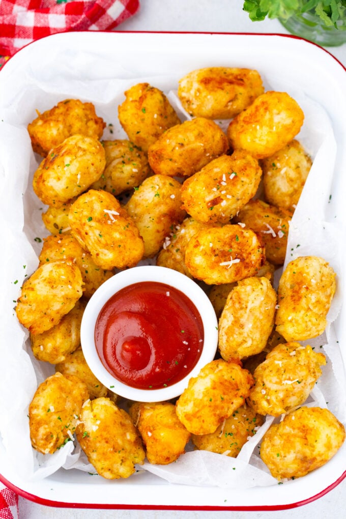 Crispy tater tots served with ketchup.