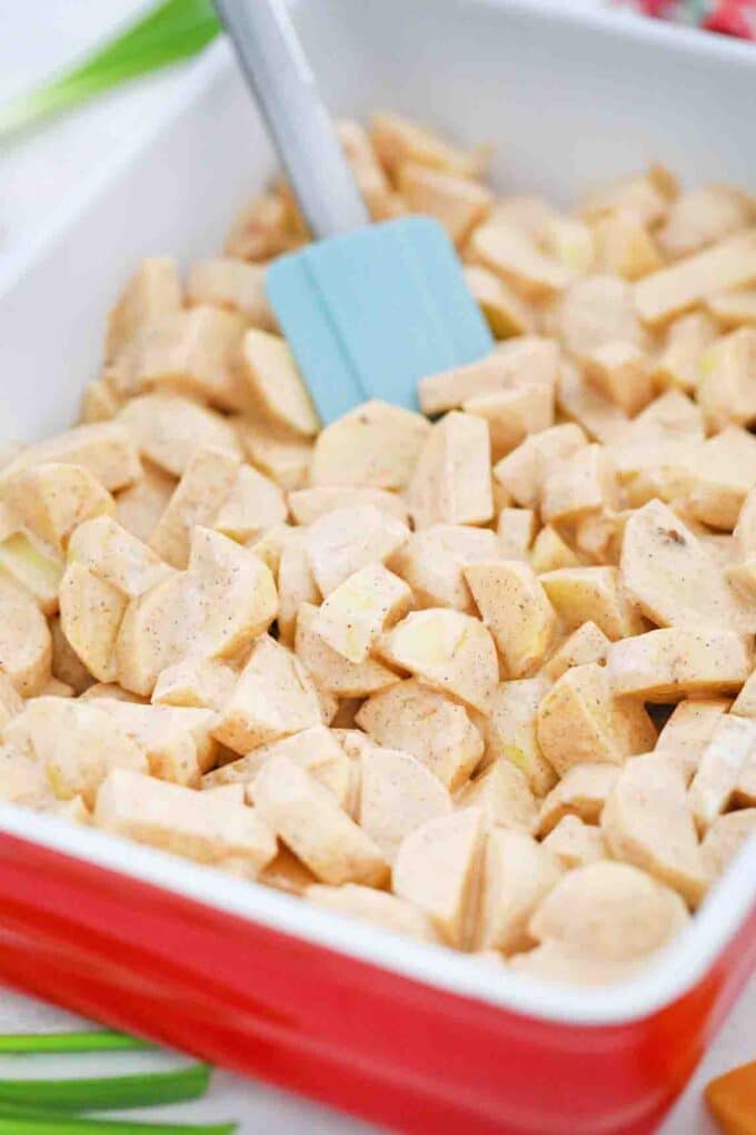 adding ranch potatoes to a casserole dish