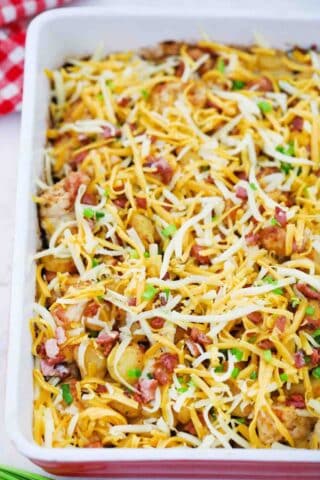 adding cheese and bacon to a casserole dish