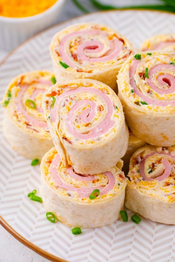 Cheesy crack turkey pinwheels stacked on a plate.
