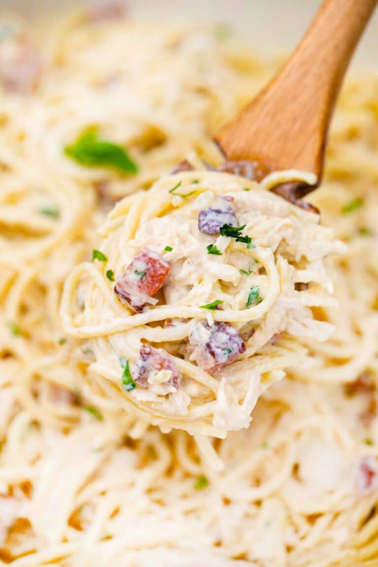 creamy chicken carbonara on a spaghetti spoon