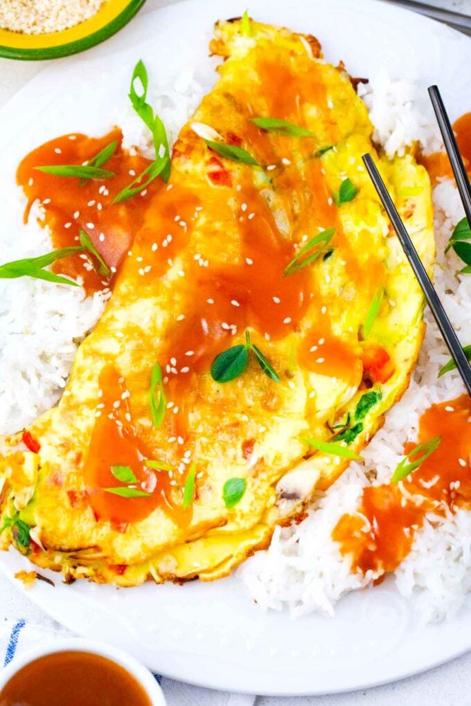 Chinese egg foo young omelette with rice and sauce