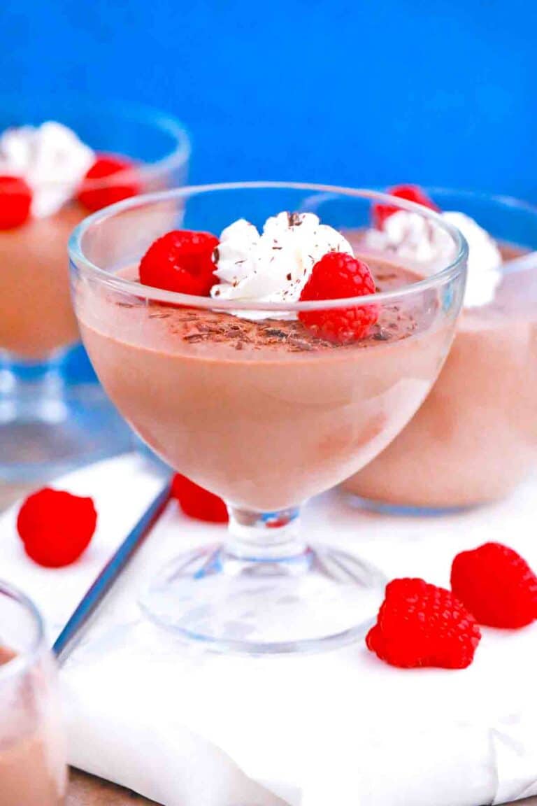 Panna Cotta served with raspberries shaved chocolate and whipped cream