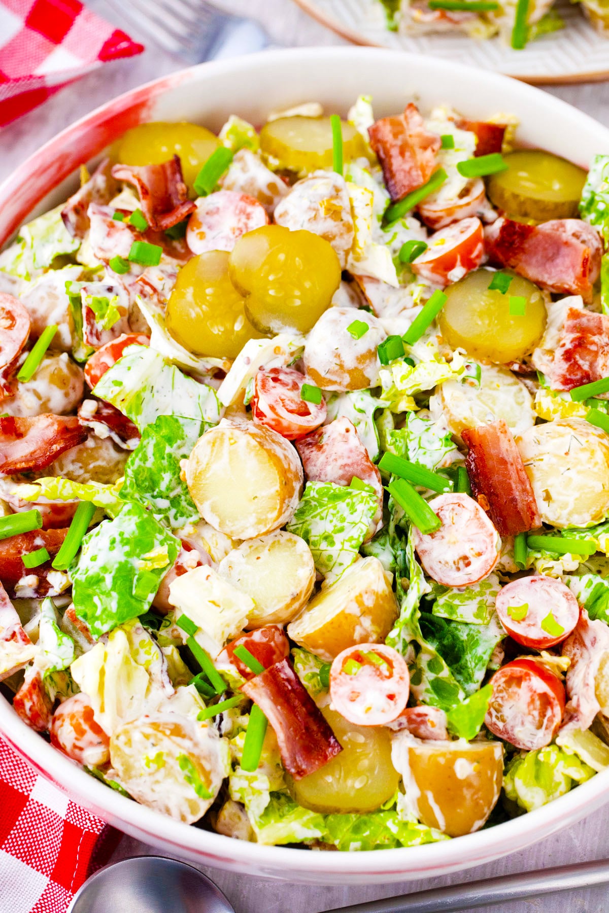 BLT potato salad with bacon, lettuce, and tomatoes.