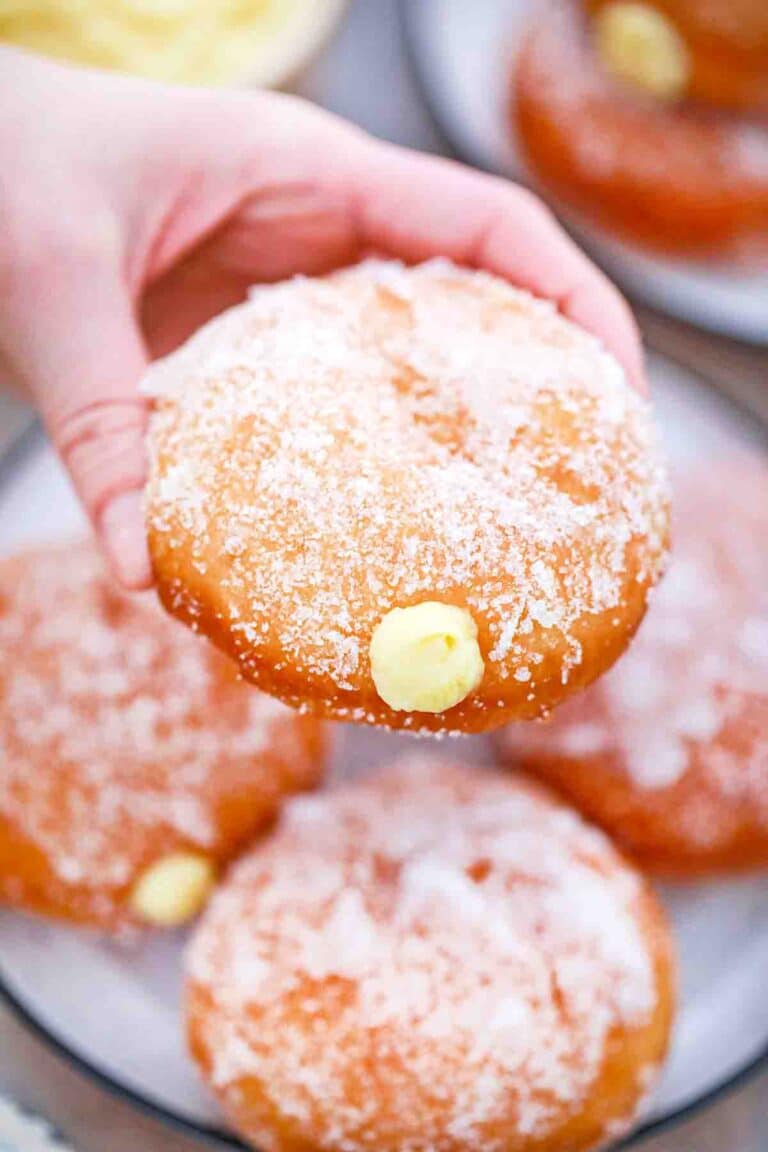 holding a custard donut