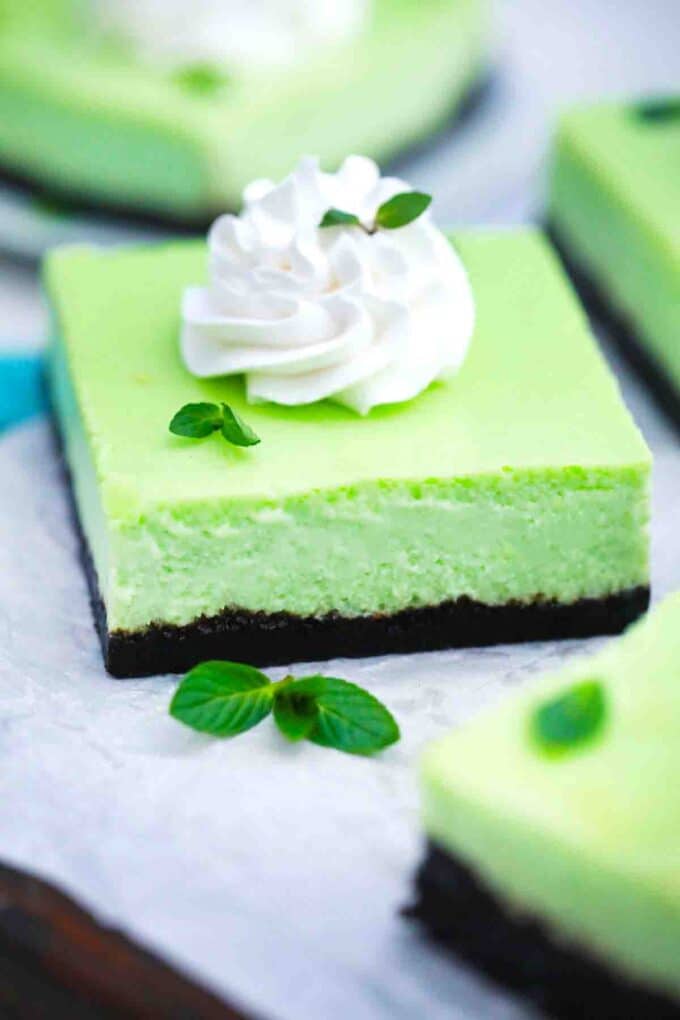 oreo mint cheesecake bars topped with whipped cream