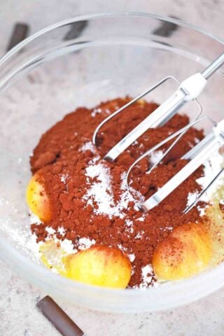 mixing eggs and cocoa powder