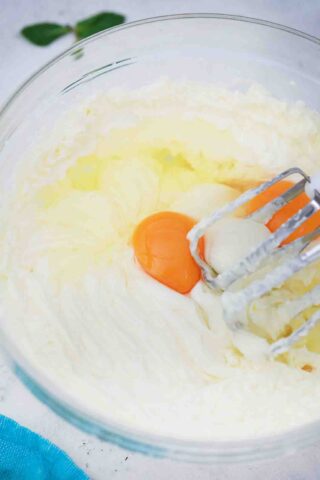 mixing eggs and cream cheese