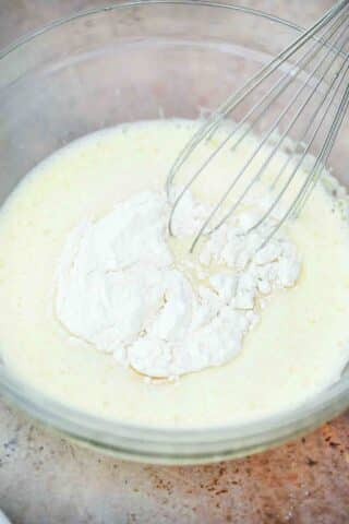 adding flour to make pastry cream