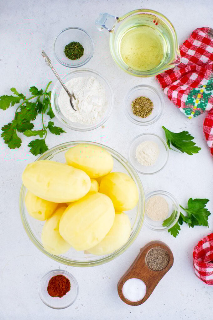 Overhead shot of homemade tater tots ingredients in bowls on a table.