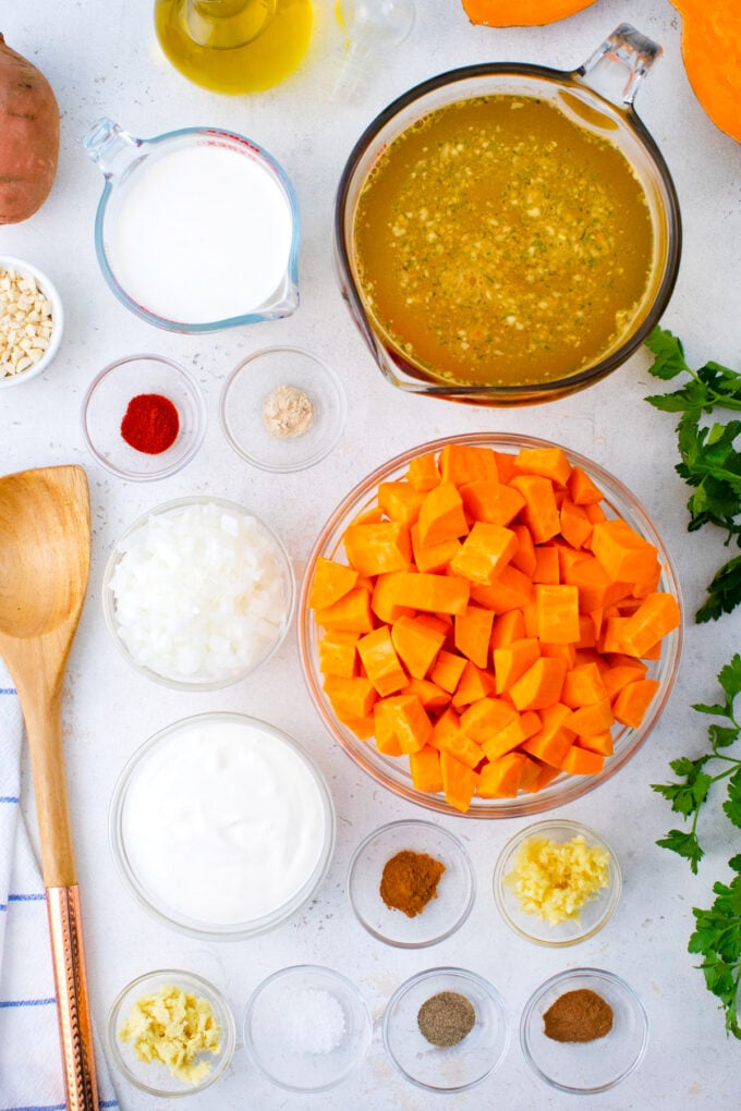 Instant Pot sweet potato soup ingredients in bowls on a white table.