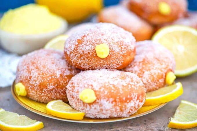 a plate of lemon curd filled donuts