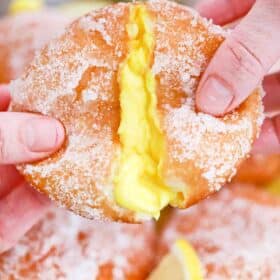 pulling apart a lemon curd filled donut and revealing a custard center