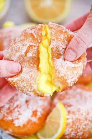 pulling apart a lemon curd filled donut and revealing a custard center