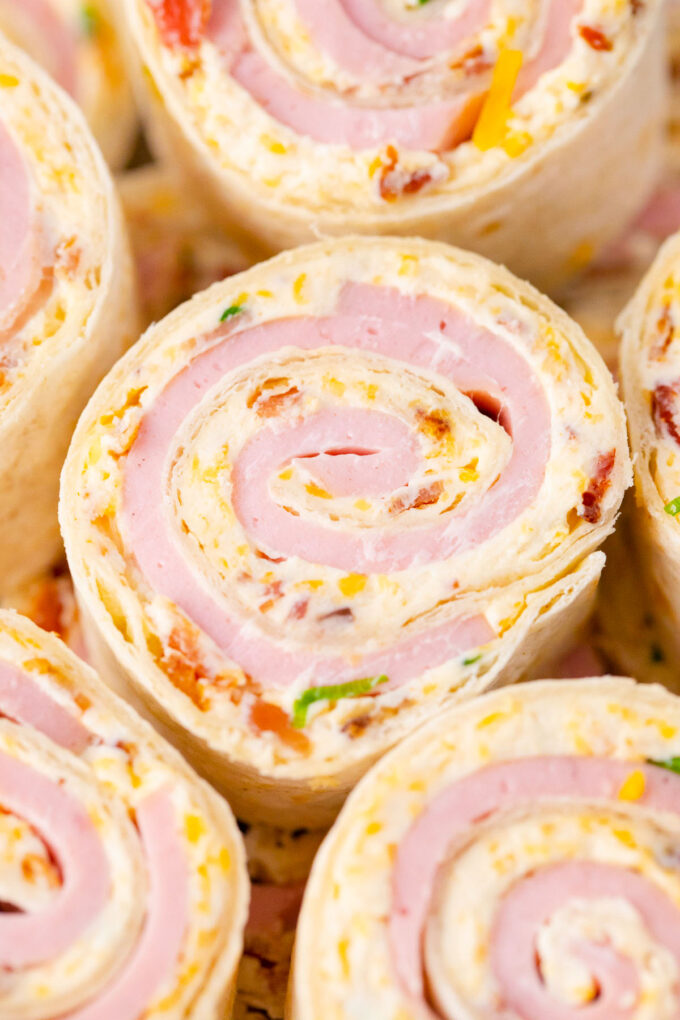Crack turkey pinwheels with cheddar cheese and bacon.