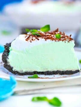 a slice of grasshopper pie topped with whipped cream and chocolate shavings