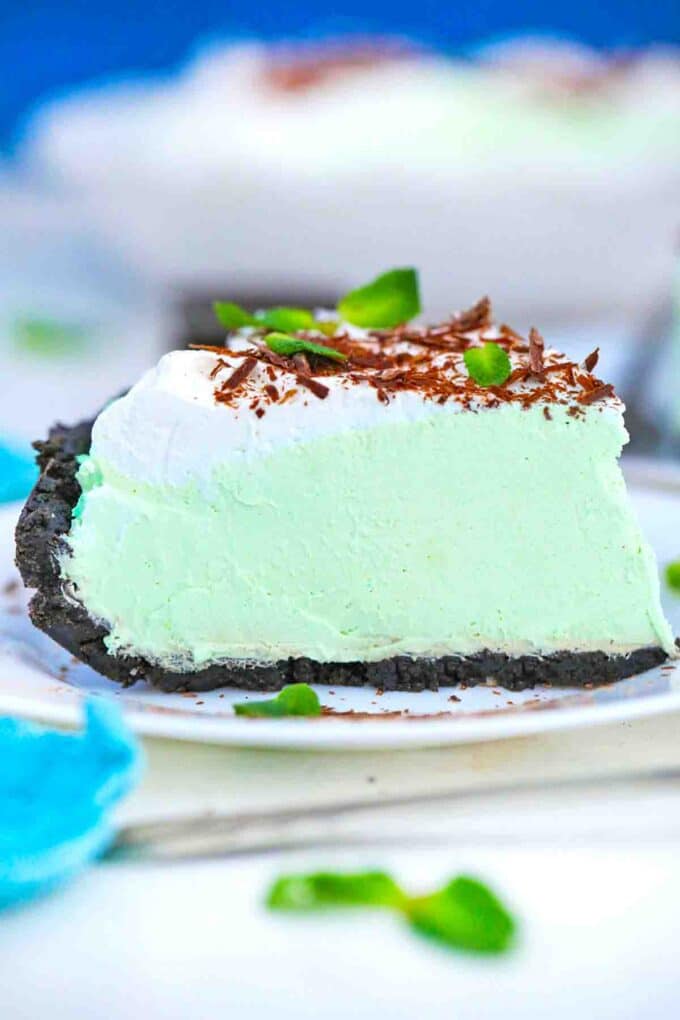 a slice of grasshopper pie topped with whipped cream and chocolate shavings