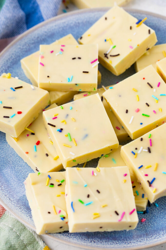 A plate of white chocolate fudge with sprinkles.
