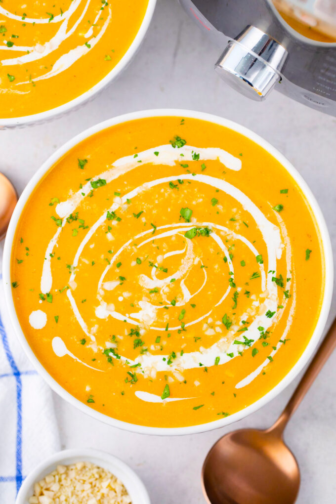 Overhead shot of creamy Instant Pot Sweet Potato Soup with a drizzle of heavy cream.