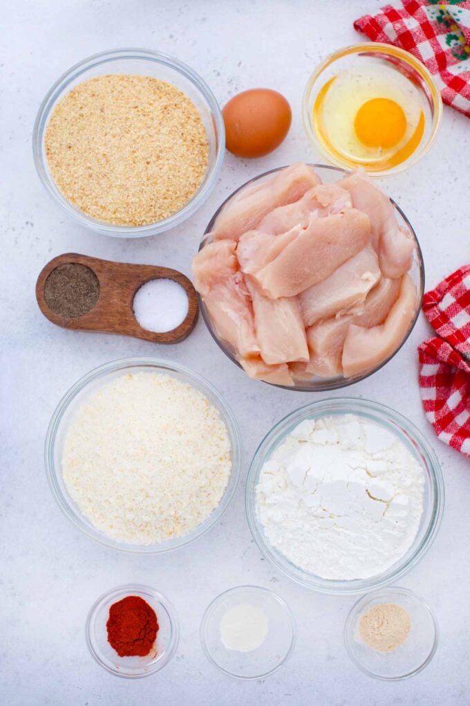 oven baked chicken tenders ingredients in bowls on a table