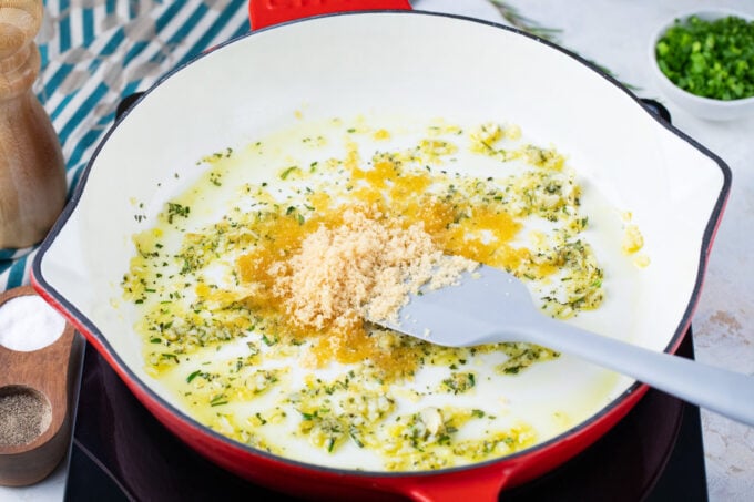 Sautéing garlic and rosemary in a pan.