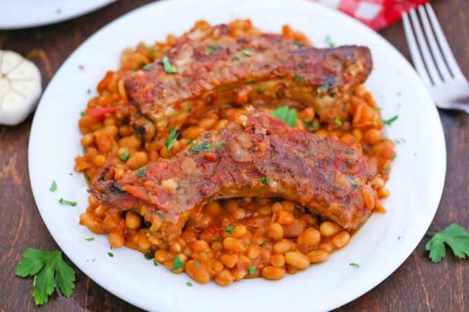 a plate of short ribs and beans
