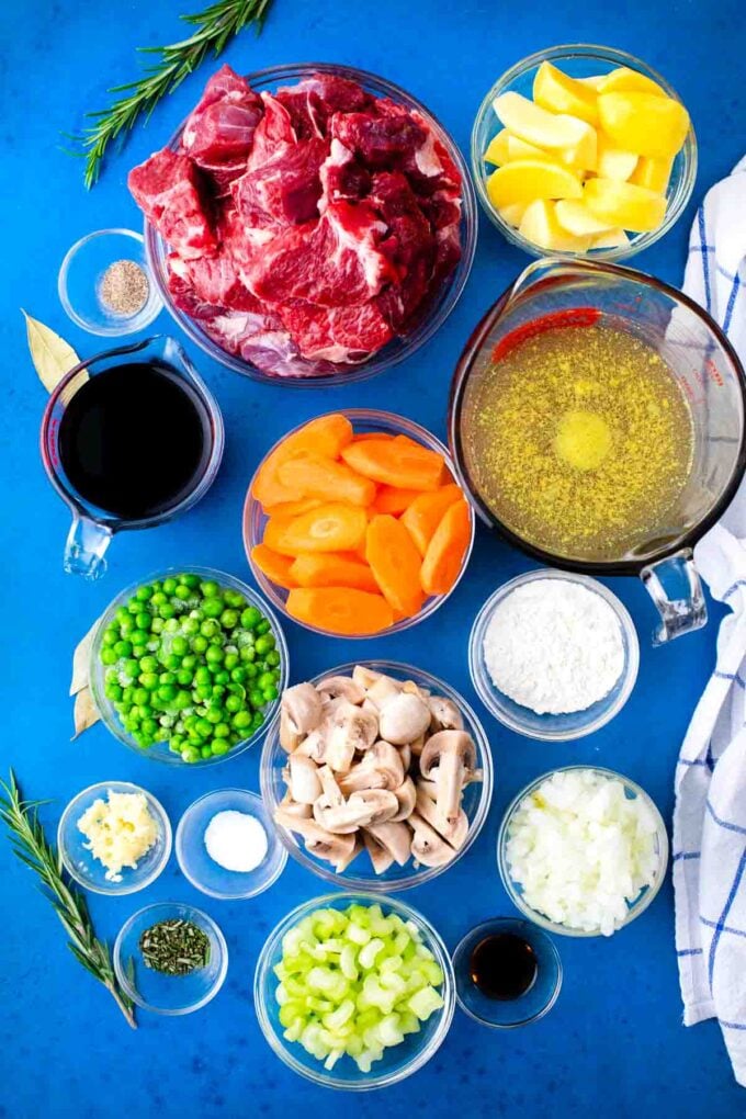 slow cooker lamb stew ingredients in bowls on a table