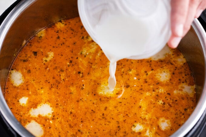 Adding cream to Instant Pot cheeseburger soup.