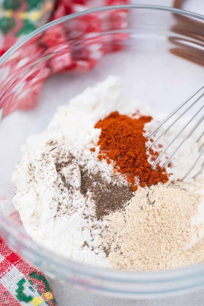 whisking different seasoning in a bowl