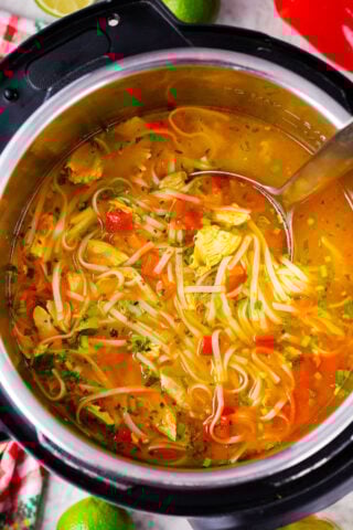 Overhead shot of Instant Pot Asian chicken noodle soup with veggies and rice noodles.