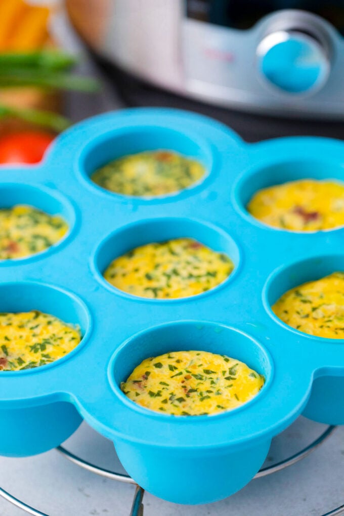 Instant Pot egg bites in a blue egg mold next to an Instant Pot.