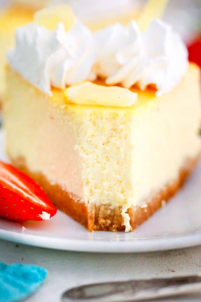 a slice of Italian ricotta cheesecake served with sliced strawberries